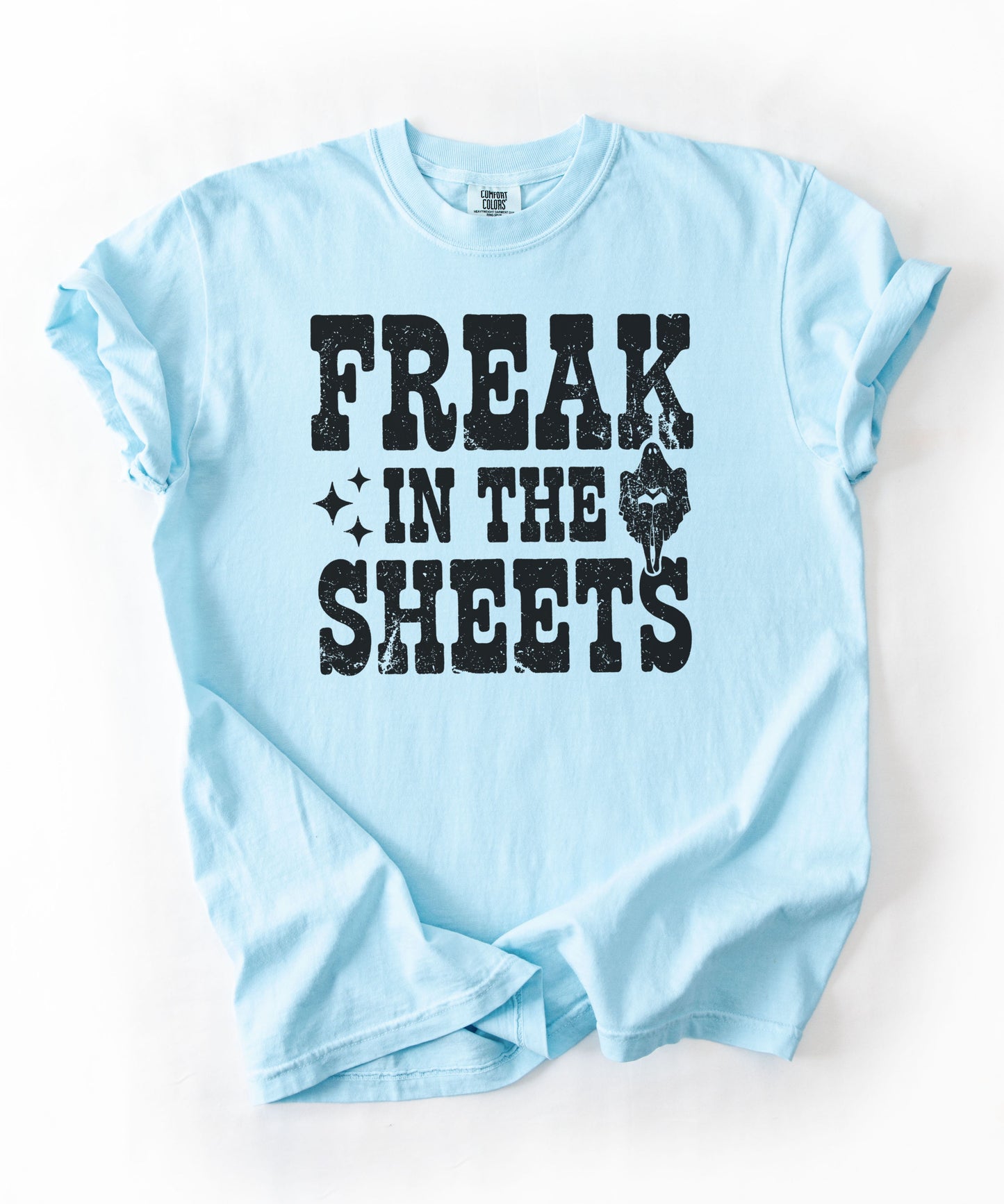 Chambray Comfort Colors Freak in the Sheets funny Halloween ghost graphic tee — distressed western lettering with ghost and sparkle accents, flat lay