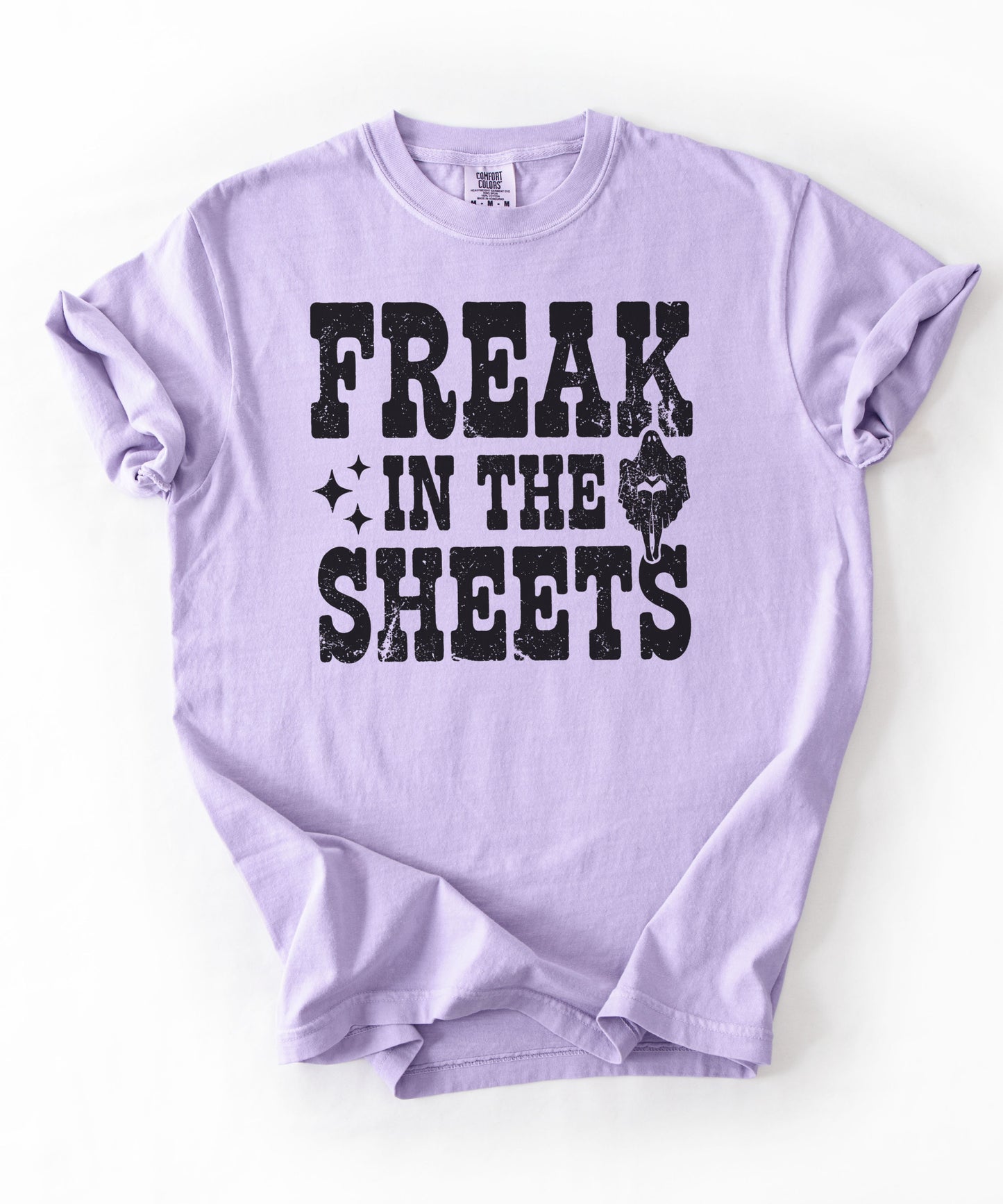 Orchid Comfort Colors Freak in the Sheets funny Halloween ghost graphic tee — distressed western lettering with ghost and sparkle accents, flat lay