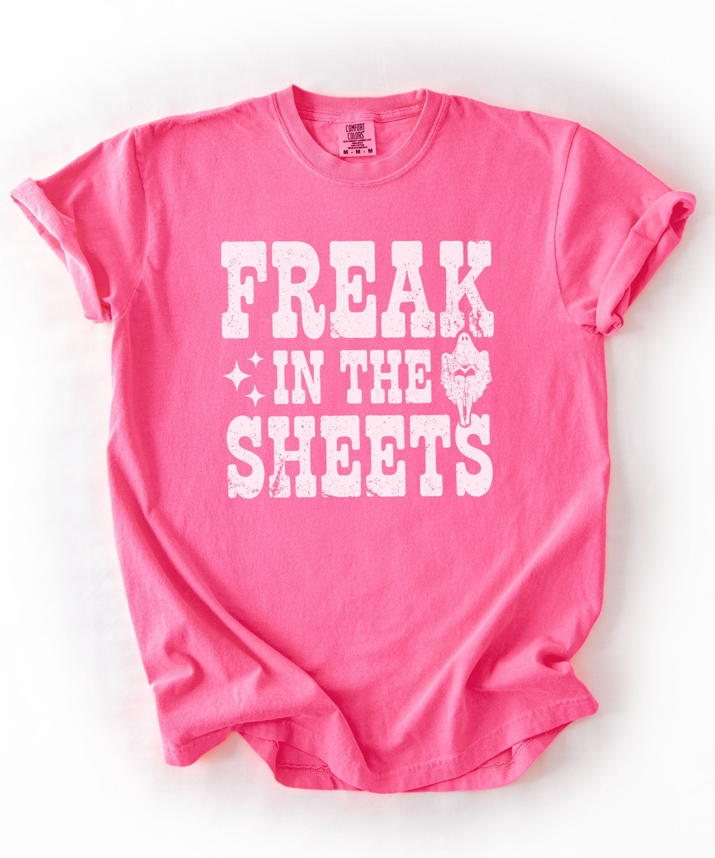 Neon Pink Comfort Colors Freak in the Sheets funny Halloween ghost graphic tee — distressed western lettering with ghost and sparkle accents, flat lay