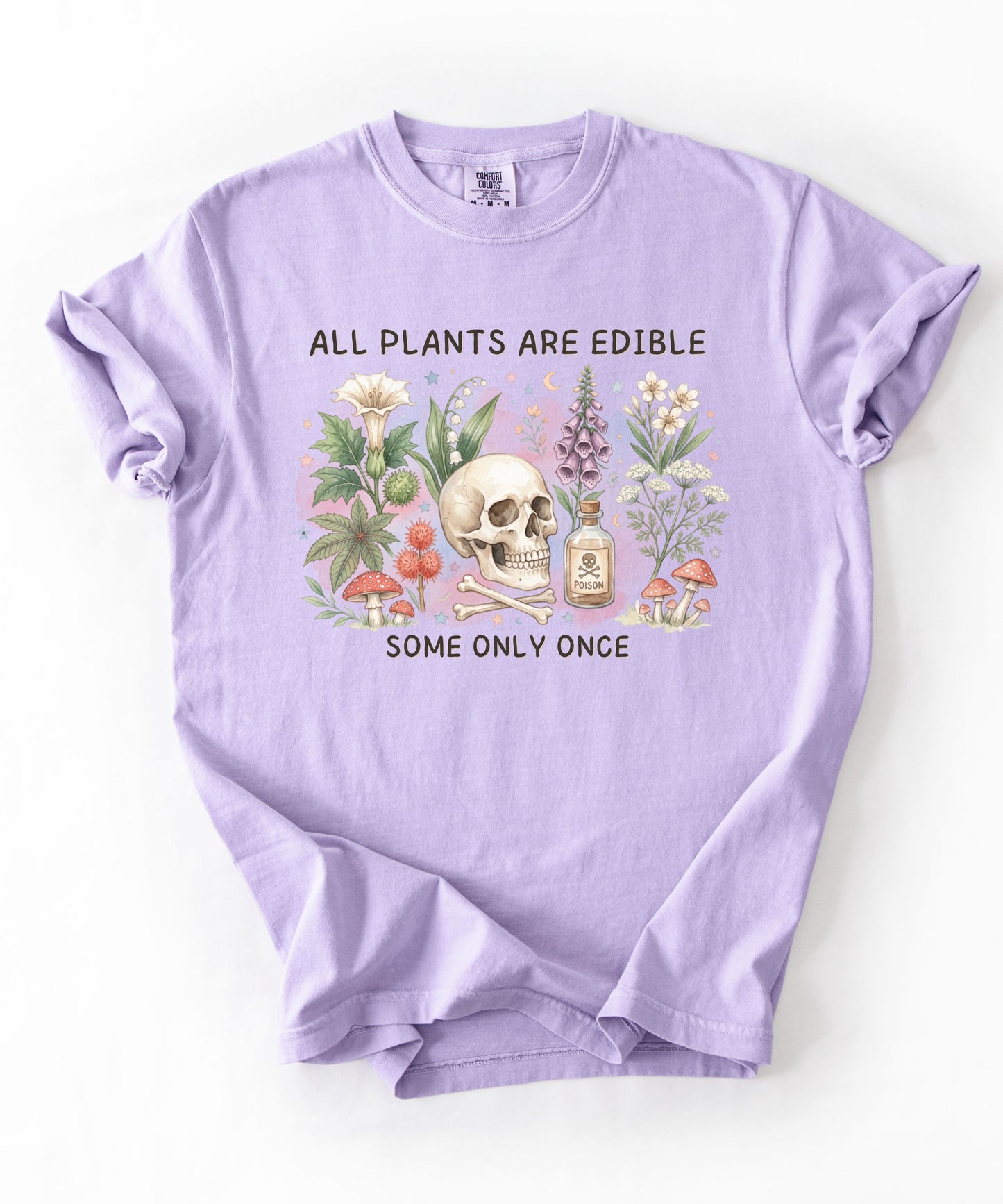 Botanical skull graphic tee featuring herbs, mushrooms, and skull illustration with phrase "All plants are edible, some only once" — front view on garment-dyed cotton Orchid Color