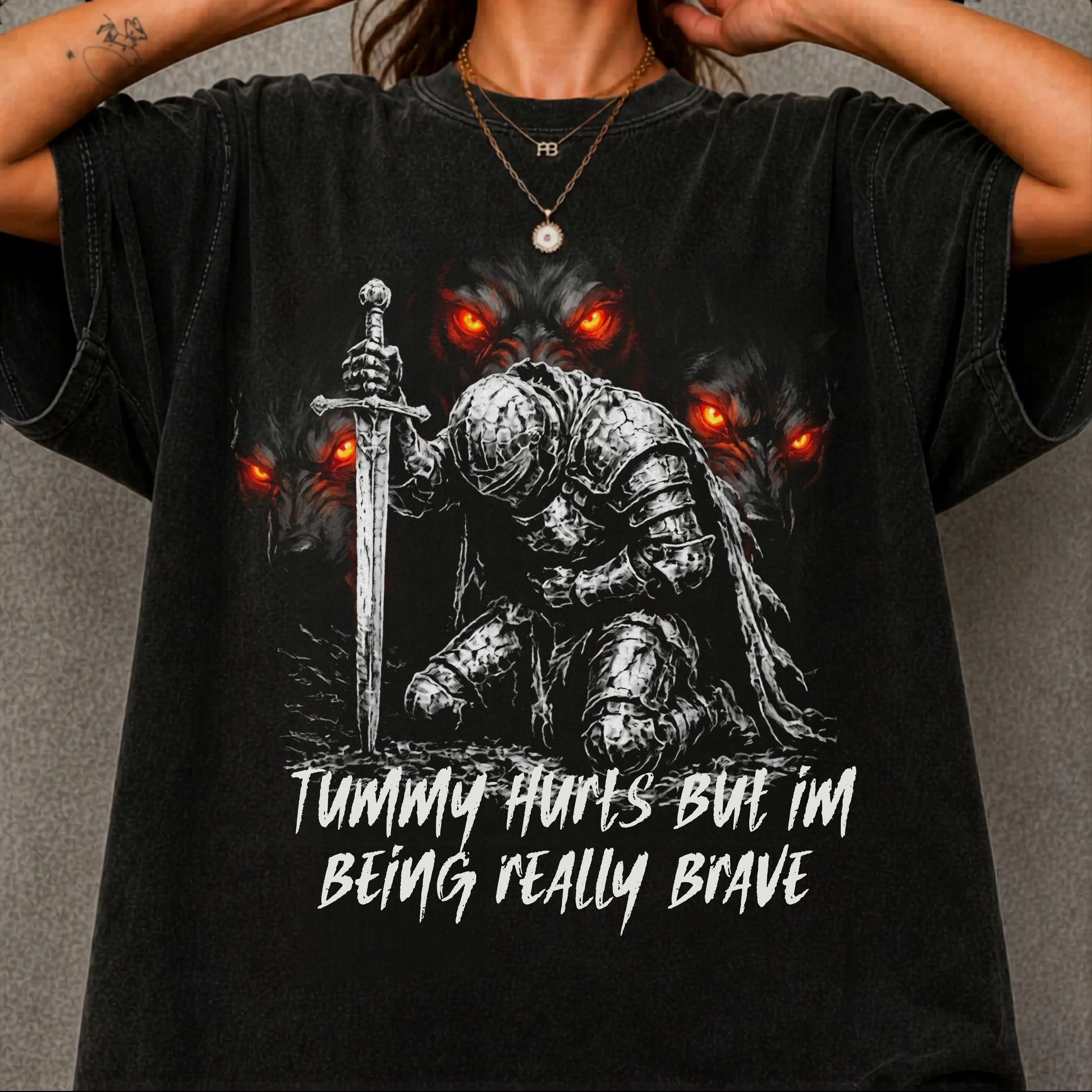 Funny knight graphic tee with Serverus and "Tummy Hurts But I'm Being Really Brave" text — Black color mockup showing relaxed fit