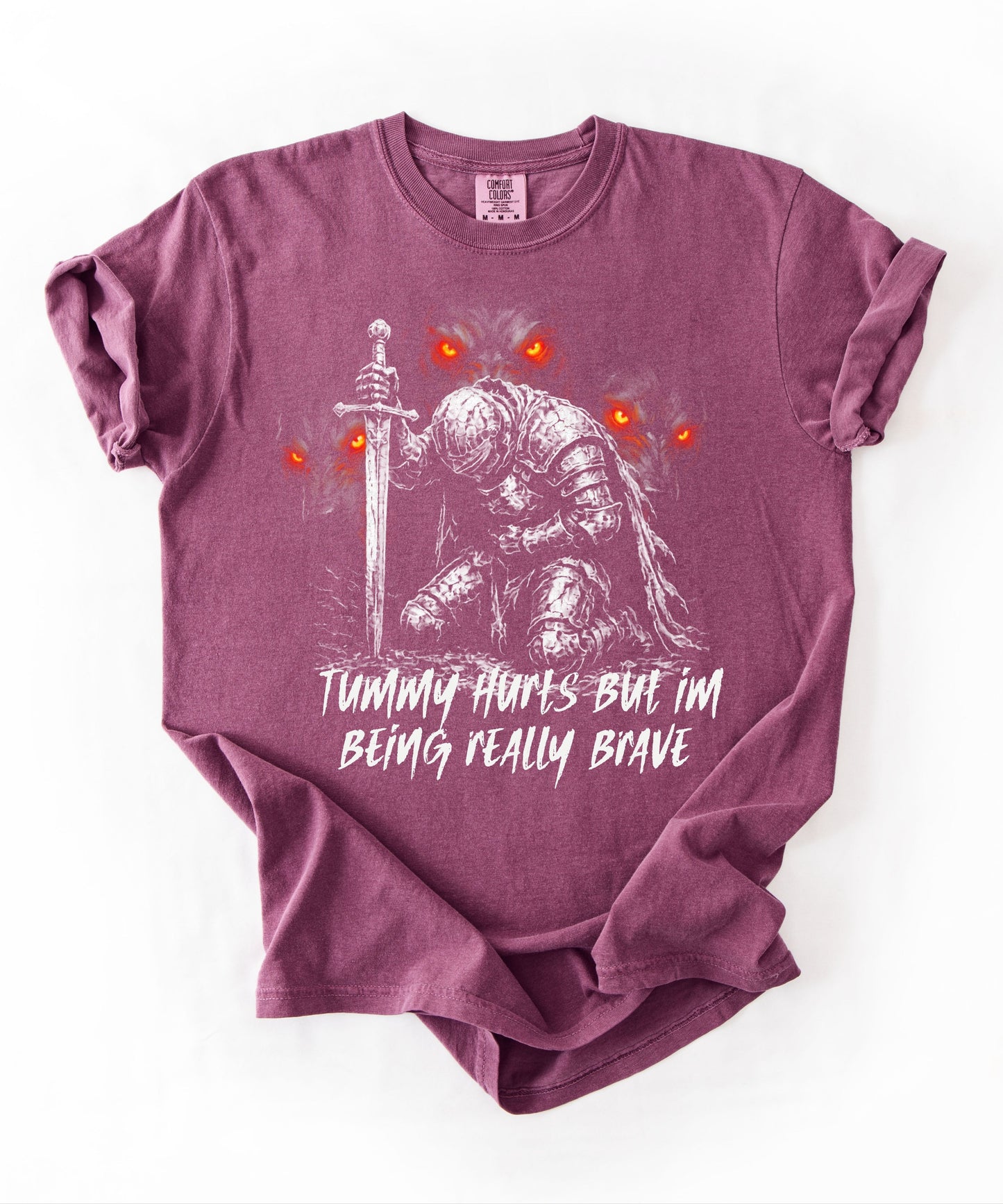 Funny knight graphic tee with Serverus and "Tummy Hurts But I'm Being Really Brave" text — Berry color mockup showing relaxed fit