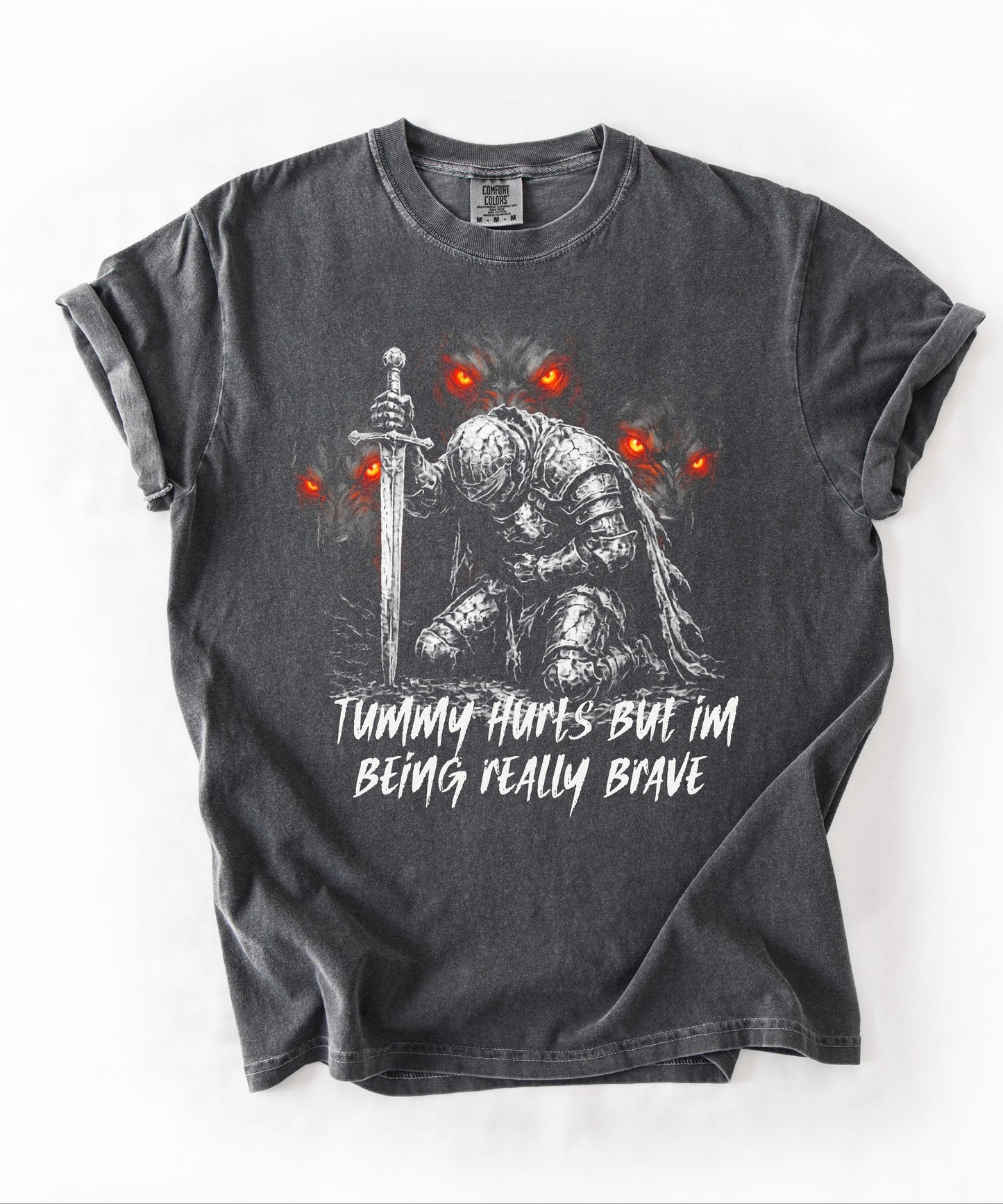 Funny knight graphic tee with Serverus and "Tummy Hurts But I'm Being Really Brave" text — Pepper color mockup showing relaxed fit