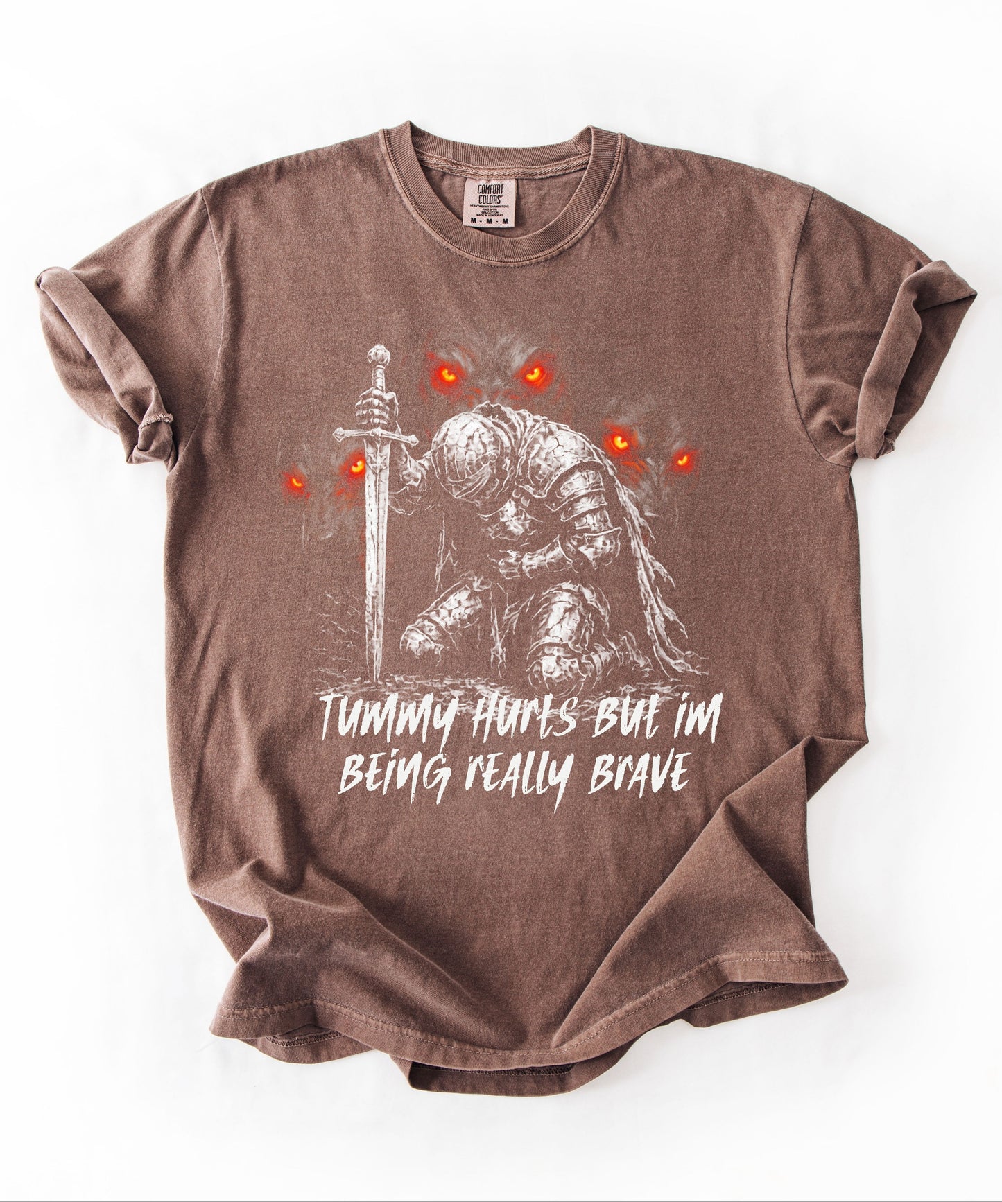 Funny knight graphic tee with Serverus and "Tummy Hurts But I'm Being Really Brave" text —Espresso color mockup showing relaxed fit