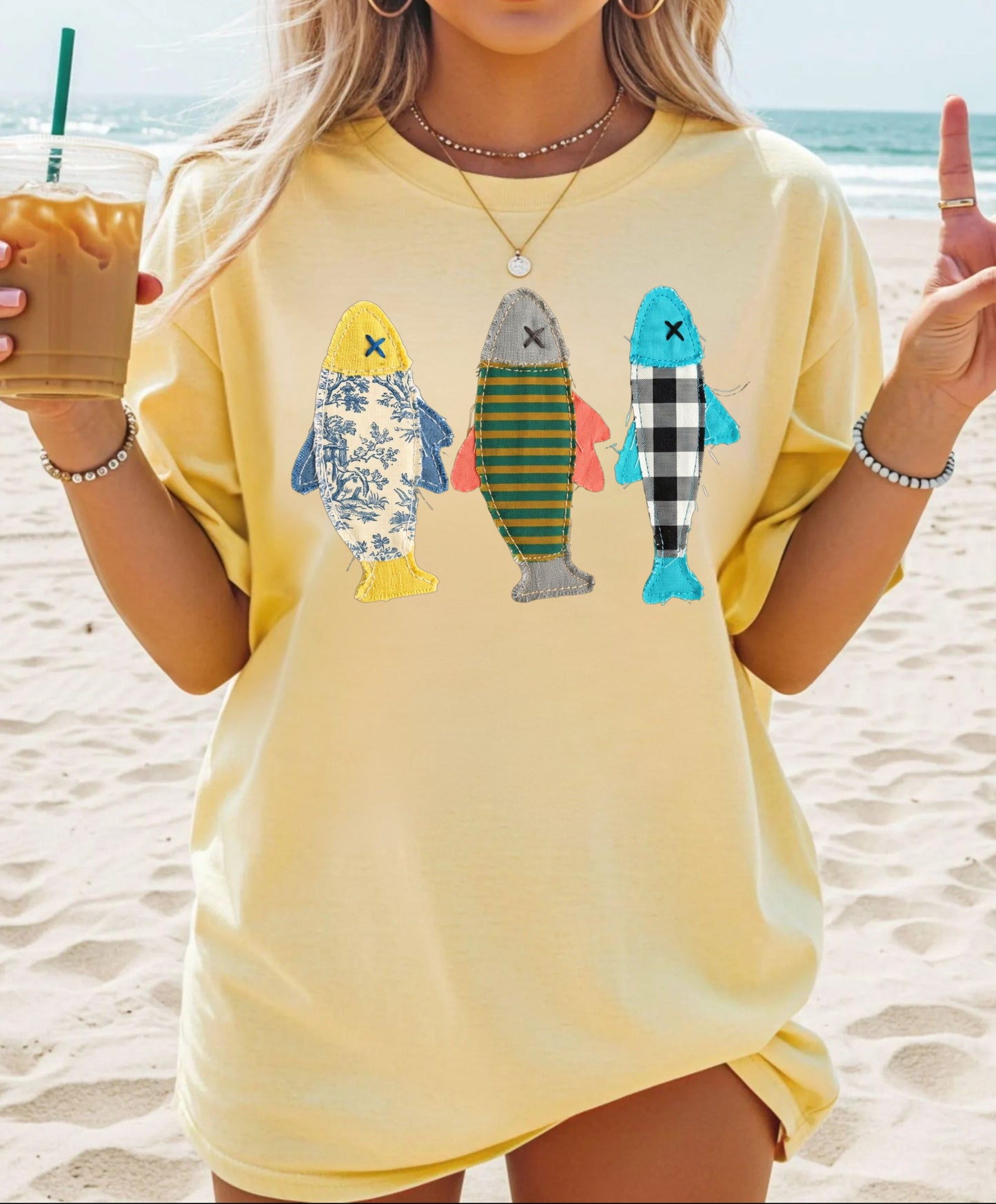 Faux patterned fish trio graphic tee in Butter showing three fish with textile-inspired faux prints — color mockup