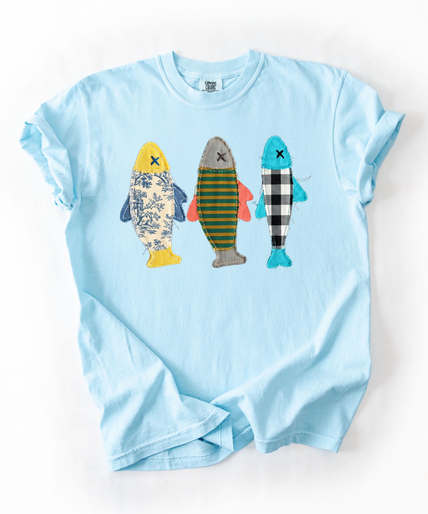Faux patterned fish trio graphic tee in Chambray featuring three fish in faux floral, faux stripe, and faux buffalo-check prints — front view on garment-dyed cotton