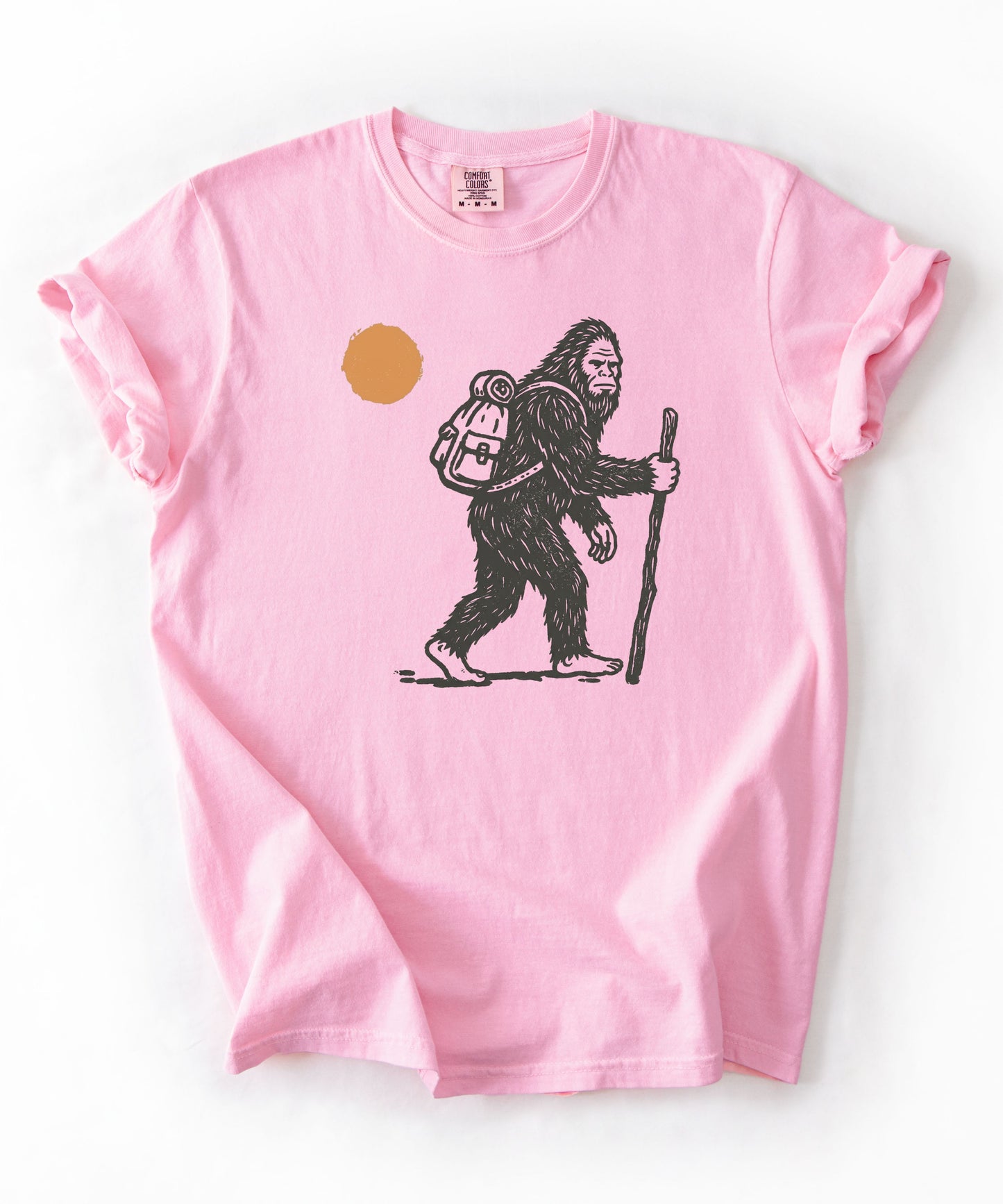 Bigfoot Hiker T-Shirt in Blossom — Sasquatch with backpack sunset graphic tee