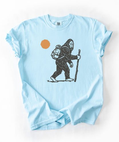 Bigfoot Hiker T-Shirt in Chambray — Sasquatch with backpack sunset graphic tee