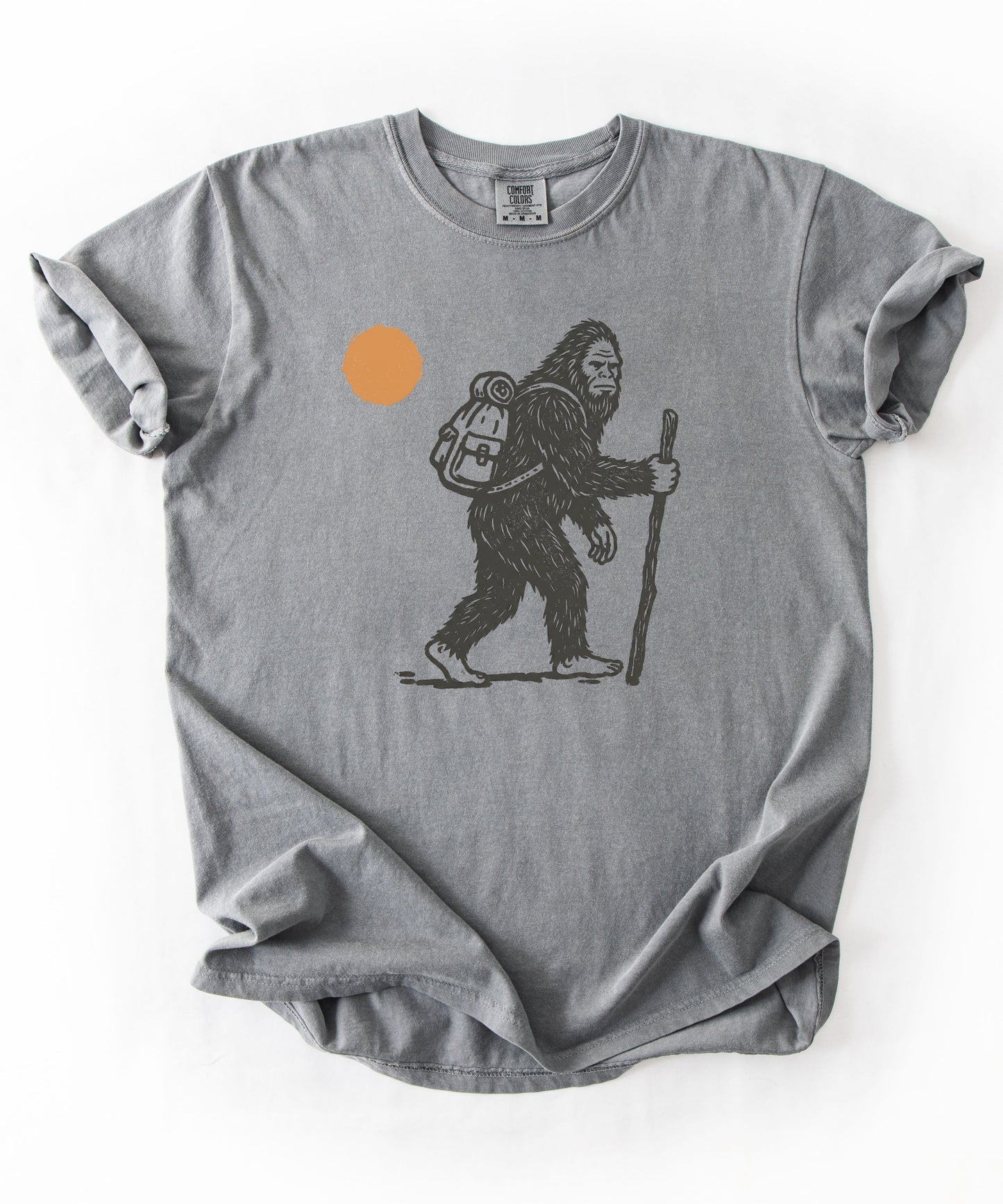 Bigfoot Hiker T-Shirt in Grey— Sasquatch with backpack sunset graphic tee
