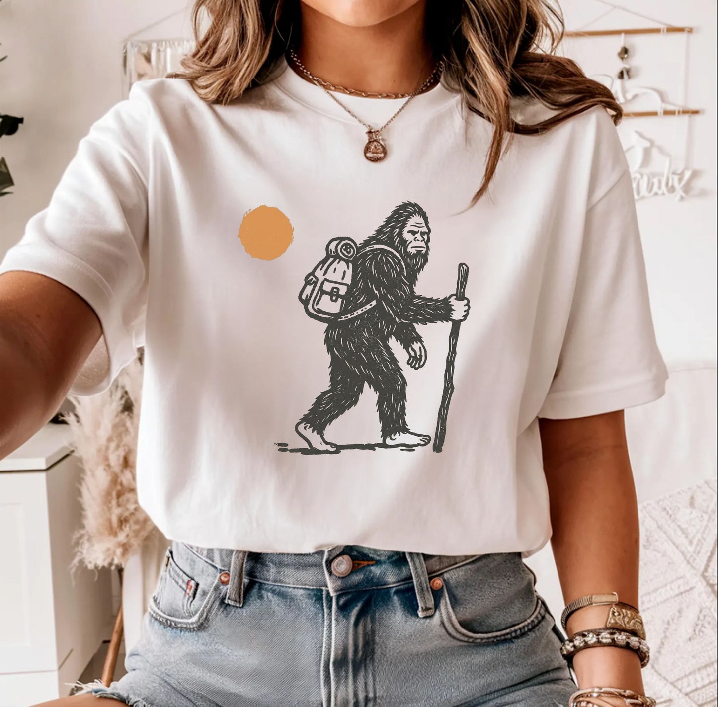 Bigfoot Hiker T-Shirt in White — Sasquatch with backpack sunset graphic tee