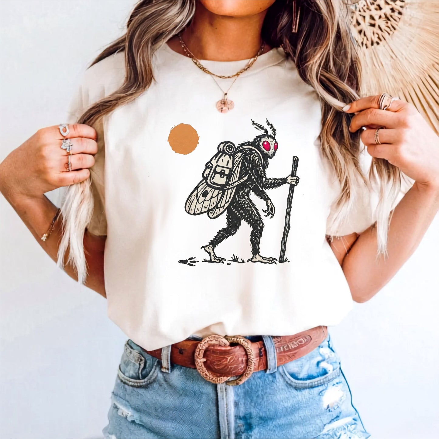 Mothman Traveler Graphic T-Shirt in Ivory — backpacking cryptid tee with sun