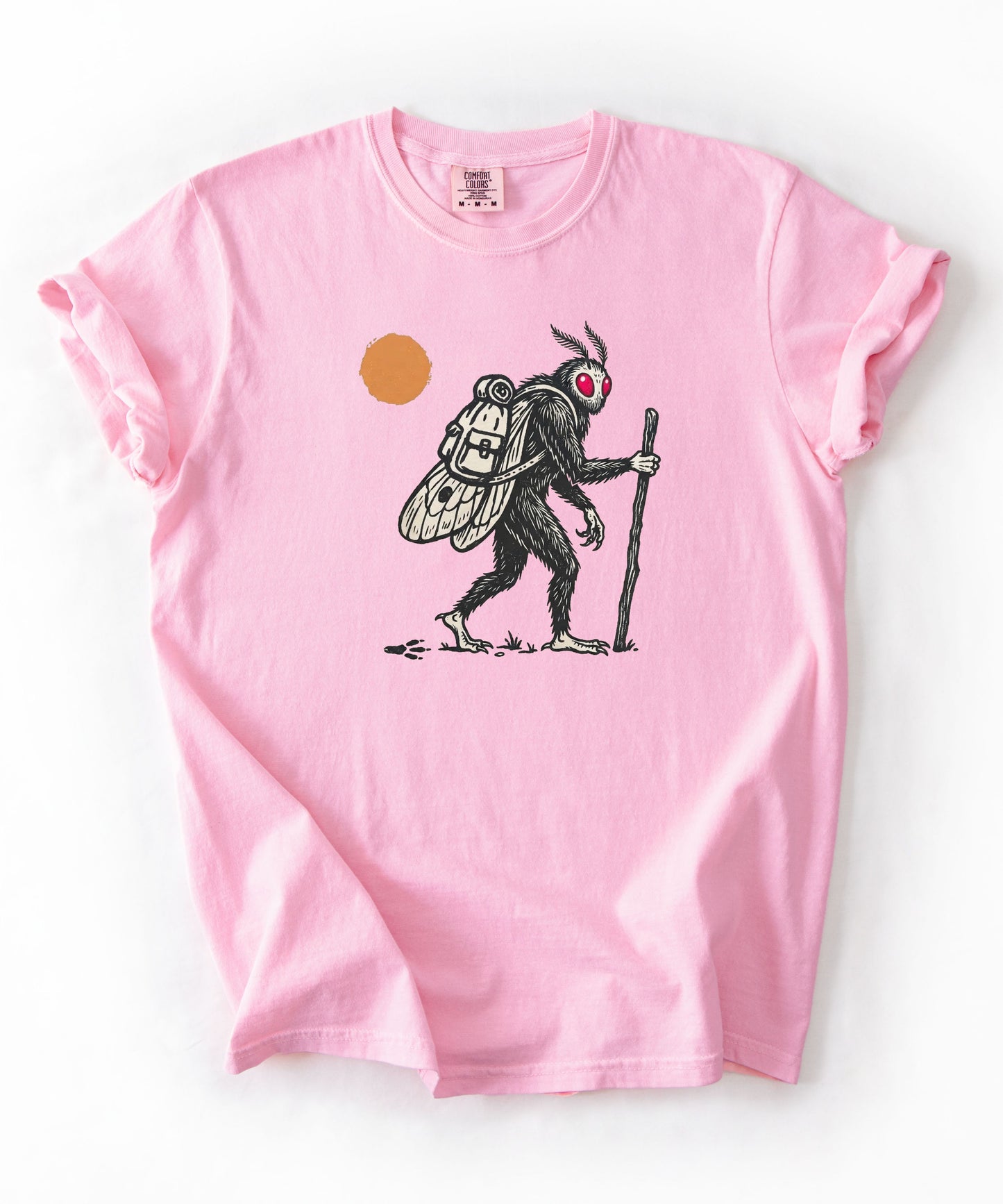 Mothman Traveler Graphic T-Shirt in Blossom— backpacking cryptid tee with sun