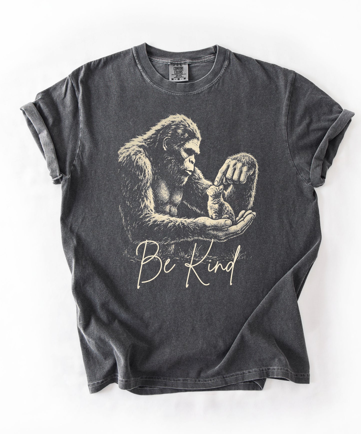 Bigfoot booping a cat on the nose graphic tee in Pepper — "Be Kind" garment-dyed heavyweight shirt