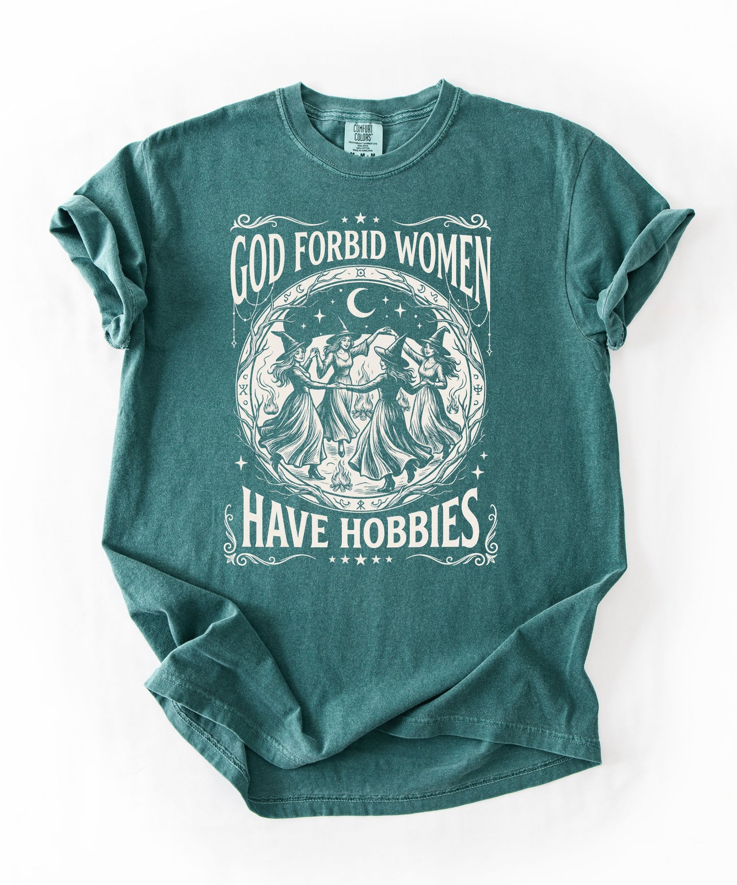 God Forbid Women Have Hobbies graphic t-shirt in Blue Spruce — vintage witch circular print on garment-dyed heavyweight cotton tee.