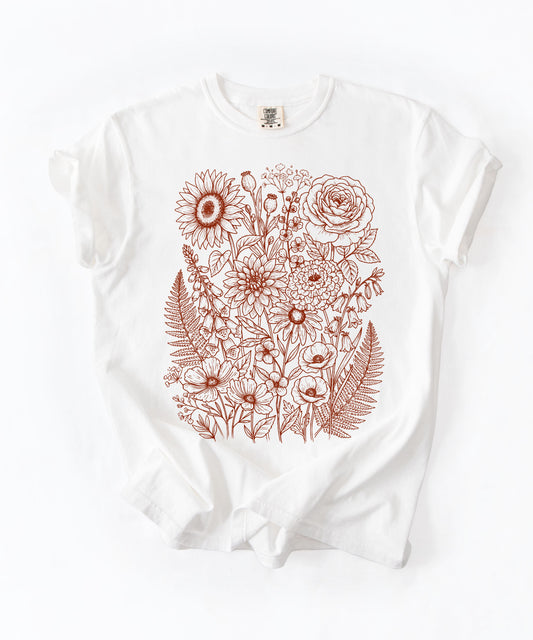 Comfort Colors®White shirt with hand-drawn botanical line art print featuring sunflower, rose, dahlia, and wildflowers