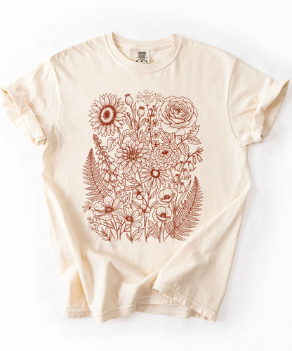 Comfort Colors® Ivory shirt with hand-drawn botanical line art print featuring sunflower, rose, dahlia, and wildflowers