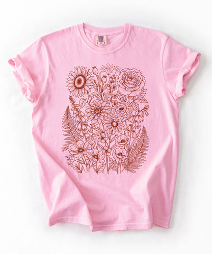 Comfort Colors® Blossom shirt with hand-drawn botanical line art print featuring sunflower, rose, dahlia, and wildflowers