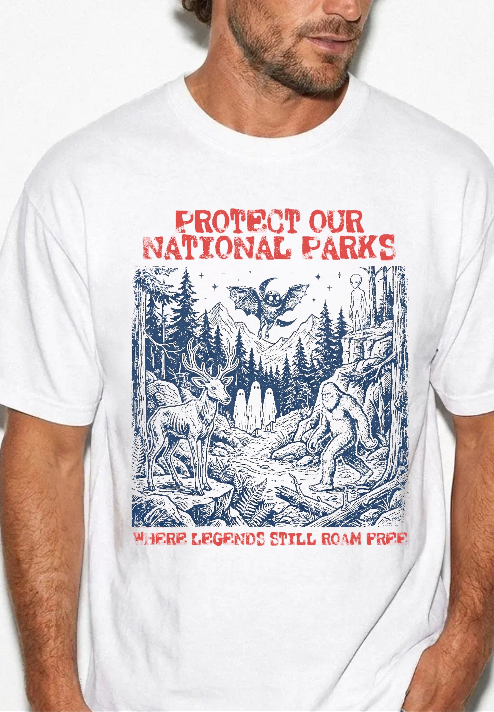 Comfort Colors® Protect Our National Parks cryptid graphic tee in [White] — Bigfoot, Mothman, aliens, ghosts wilderness scene, flat lay