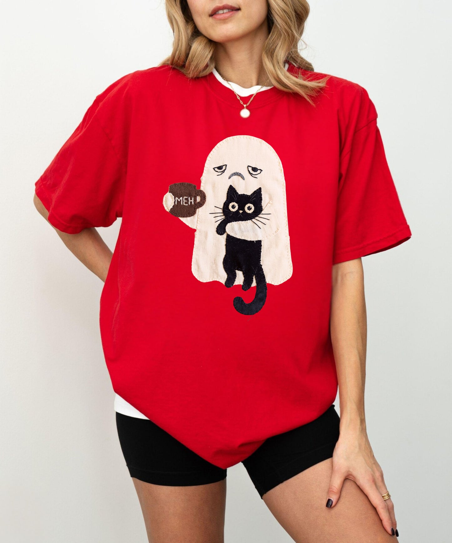    Grumpy ghost holding MEH mug with black cat graphic on red Comfort Colors garment-dyed tee