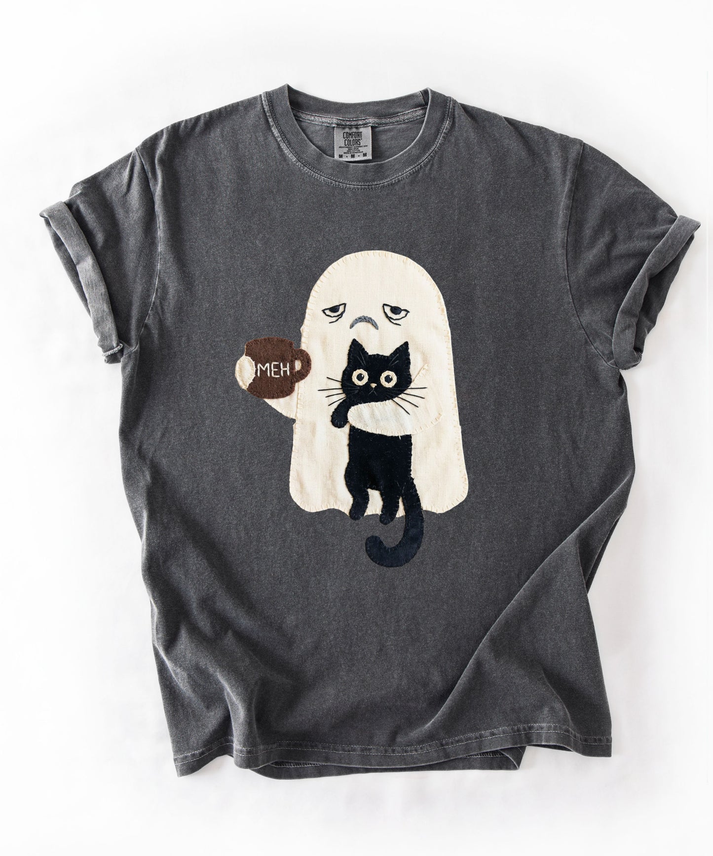 Grumpy ghost holding MEH mug with black cat graphic on Pepper Comfort Colors garment-dyed tee