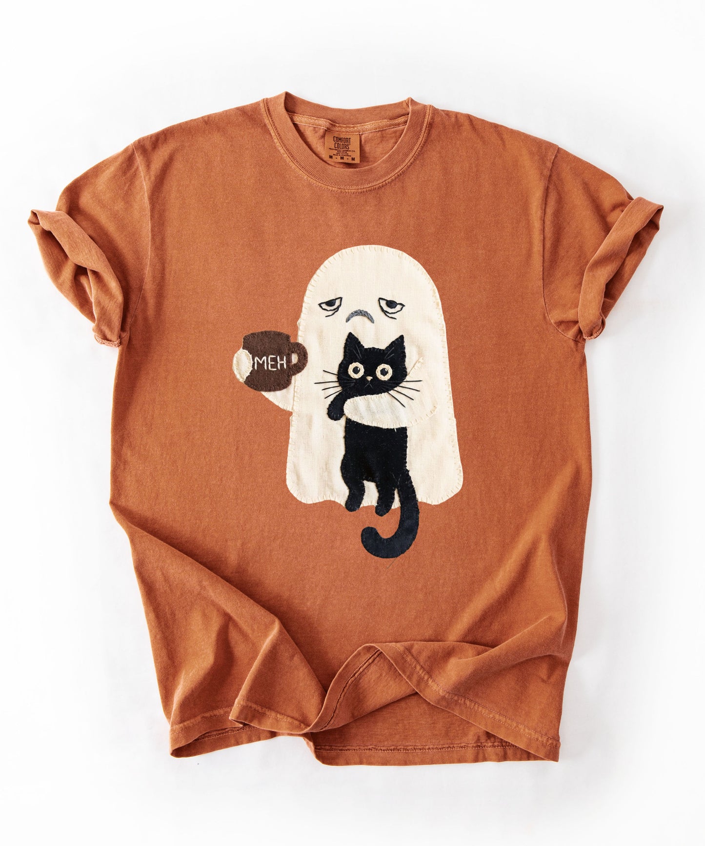 Grumpy ghost holding MEH mug with black cat graphic on Yam Comfort Colors garment-dyed tee