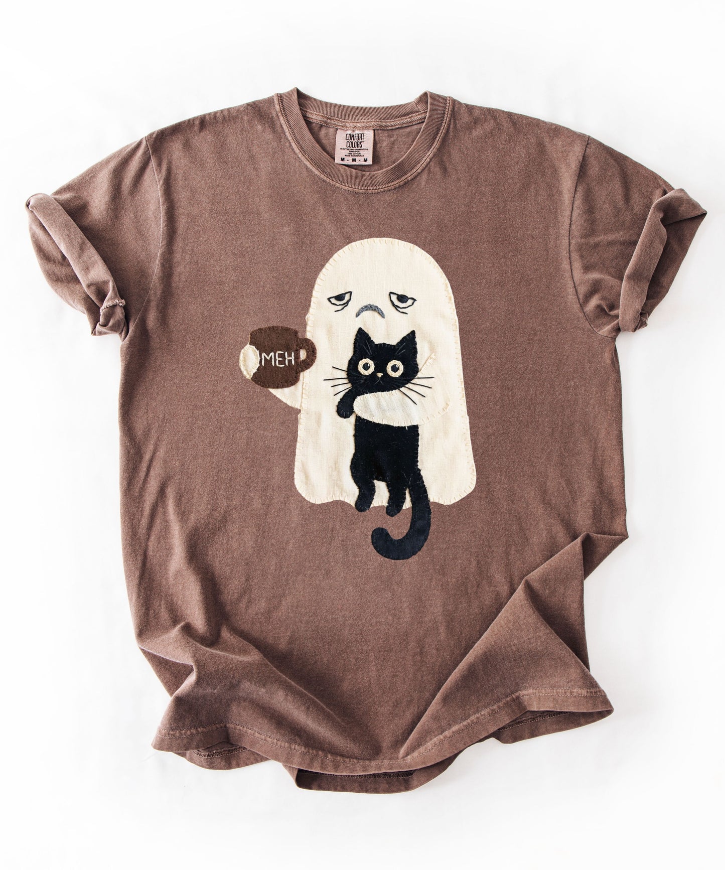Grumpy ghost holding MEH mug with black cat graphic on Espresso Comfort Colors garment-dyed tee