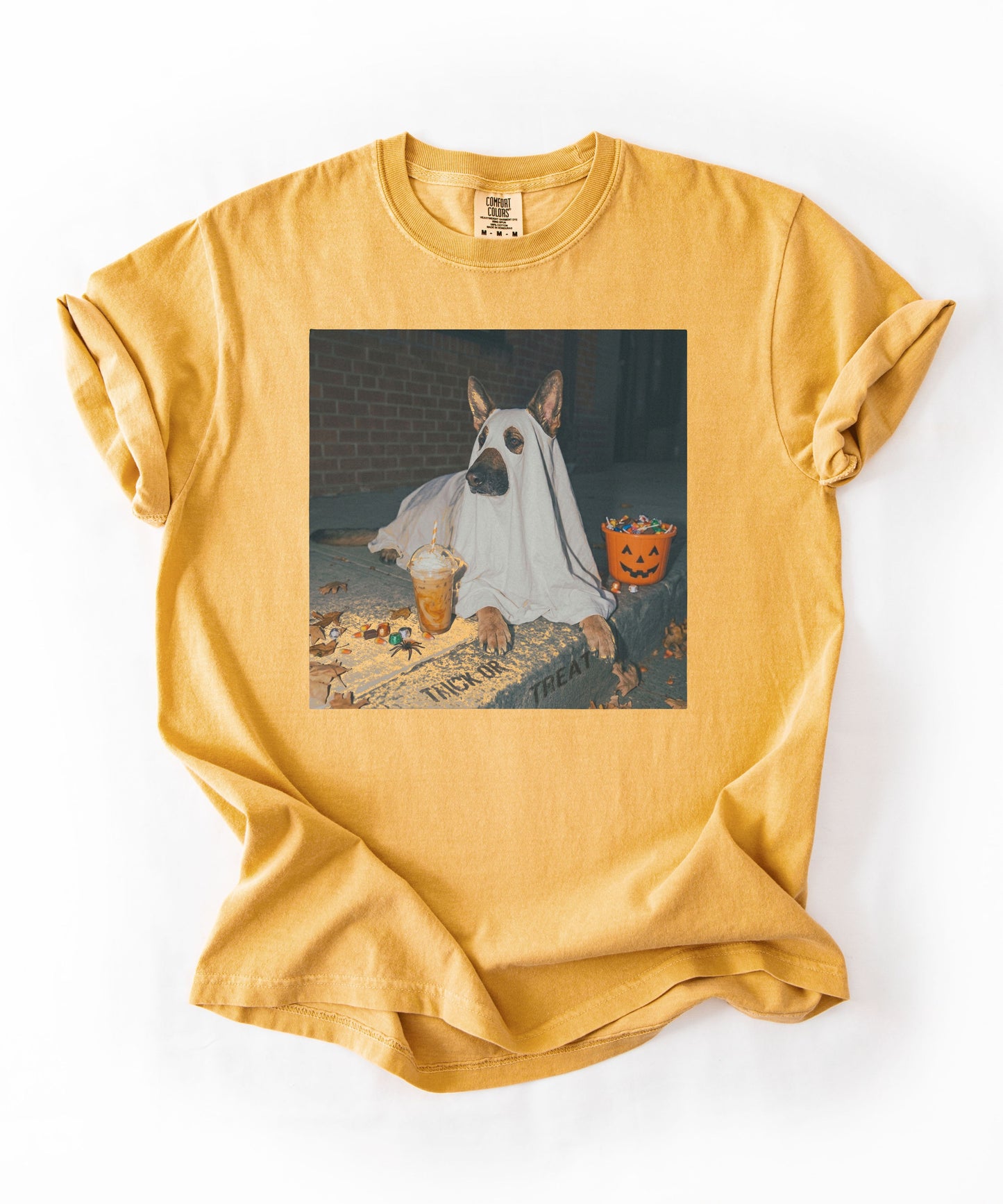 Mustard garment-dyed t-shirt with German Shepherd in ghost costume jack-o'-lantern treat bucket — Halloween ghost dog tee by GodaStudio