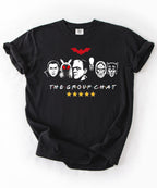 Black garment-dyed unisex t-shirt featuring The Group Chat horror monster squad graphic — Dracula, Mothman with red eyes, Frankenstein, Slender Man, Bigfoot, and Werewolf faces with red bat above and five gold stars below