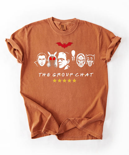 Yam garment-dyed unisex t-shirt featuring The Group Chat horror monster squad graphic — Dracula, Mothman with red eyes, Frankenstein, Slender Man, Bigfoot, and Werewolf faces with red bat above and five gold stars below