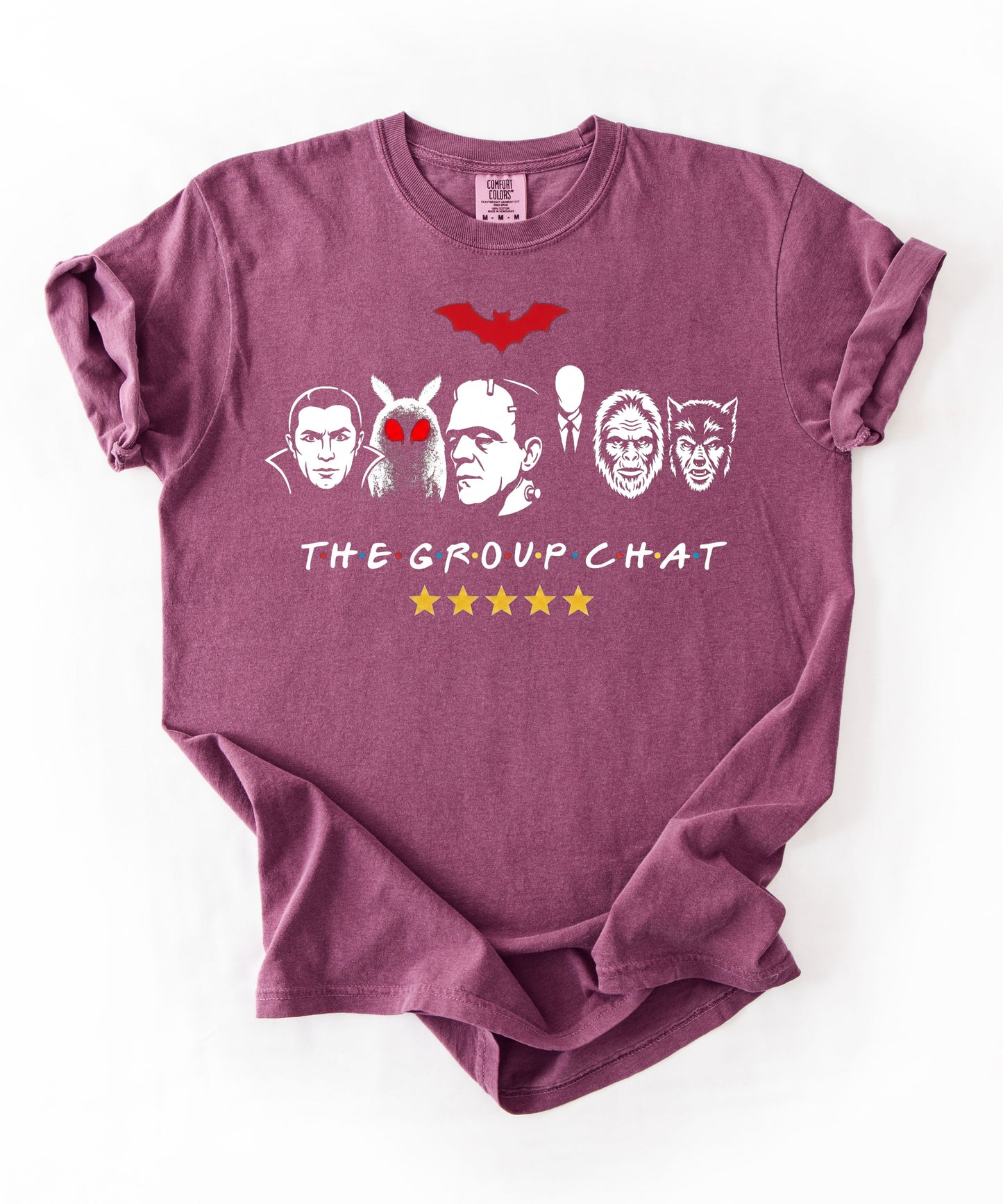 Berry garment-dyed unisex t-shirt featuring The Group Chat horror monster squad graphic — Dracula, Mothman with red eyes, Frankenstein, Slender Man, Bigfoot, and Werewolf faces with red bat above and five gold stars below