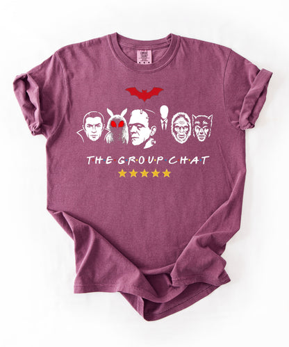 Berry garment-dyed unisex t-shirt featuring The Group Chat horror monster squad graphic — Dracula, Mothman with red eyes, Frankenstein, Slender Man, Bigfoot, and Werewolf faces with red bat above and five gold stars below