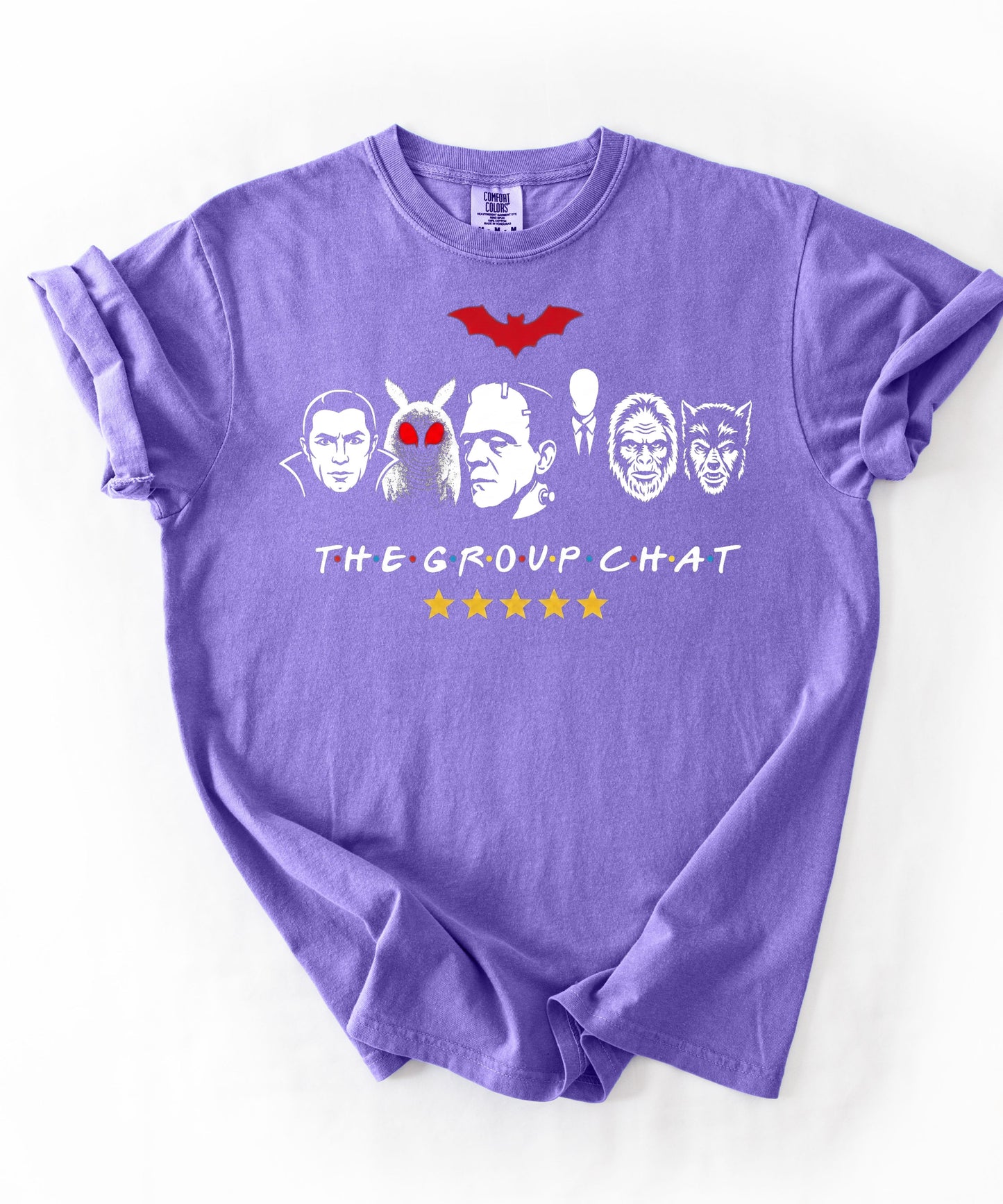 Violet garment-dyed unisex t-shirt featuring The Group Chat horror monster squad graphic — Dracula, Mothman with red eyes, Frankenstein, Slender Man, Bigfoot, and Werewolf faces with red bat above and five gold stars below