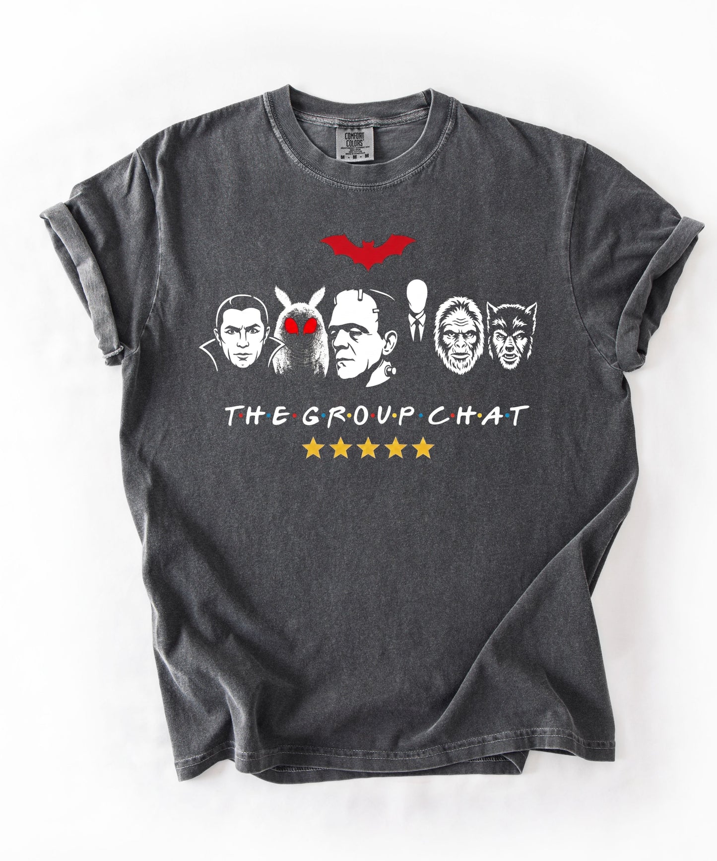 Pepper garment-dyed unisex t-shirt featuring The Group Chat horror monster squad graphic — Dracula, Mothman with red eyes, Frankenstein, Slender Man, Bigfoot, and Werewolf faces with red bat above and five gold stars below