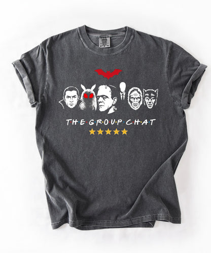 Pepper garment-dyed unisex t-shirt featuring The Group Chat horror monster squad graphic — Dracula, Mothman with red eyes, Frankenstein, Slender Man, Bigfoot, and Werewolf faces with red bat above and five gold stars below