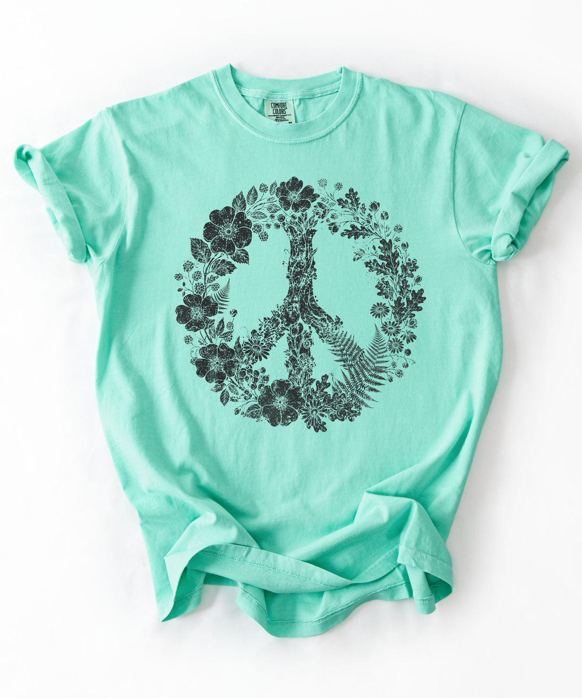 An Island Reef short-sleeve t-shirt with a black graphic of a peace sign formed by flowers and leaves, laid flat on a white background.