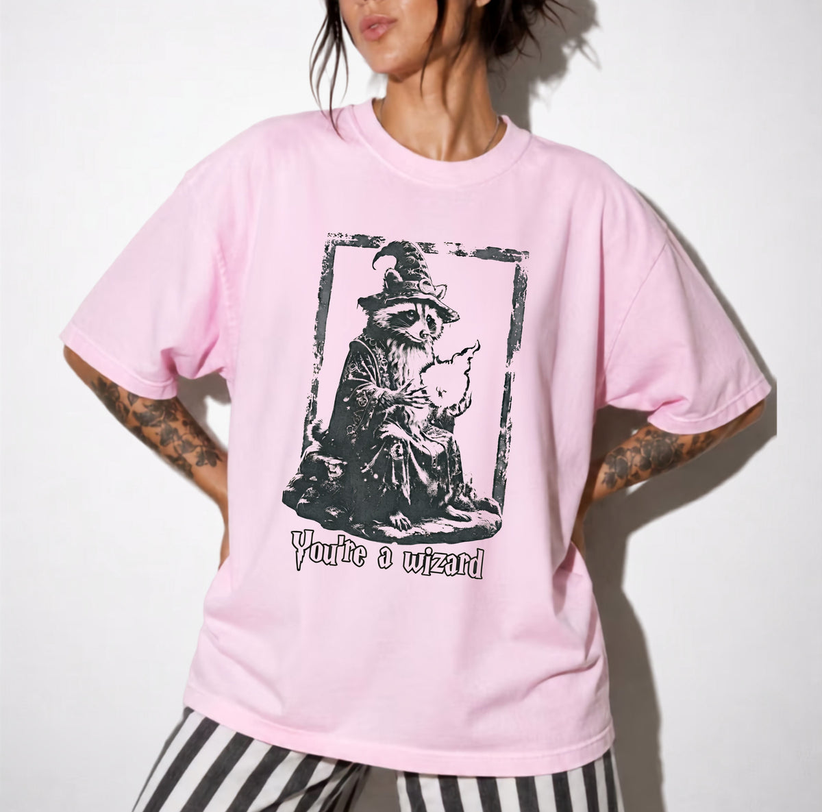 Funny wizard raccoon graphic tee in Blossom, vintage engraving style with "You're a Wizard Harry" text