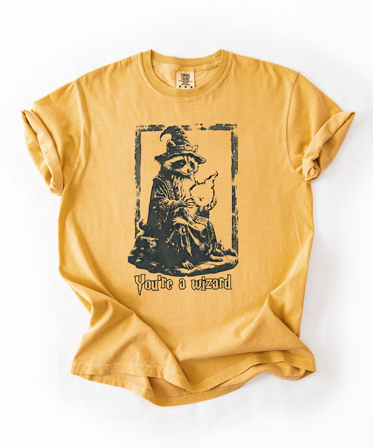 Funny wizard raccoon graphic tee in Mustard, vintage engraving style with "You're a Wizard Harry" text