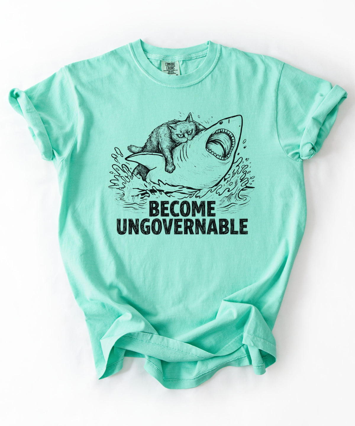 Island Reef t-shirt with a graphic of a cat on a Shark and the text 'BECOME UNGOVERNABLE'. 