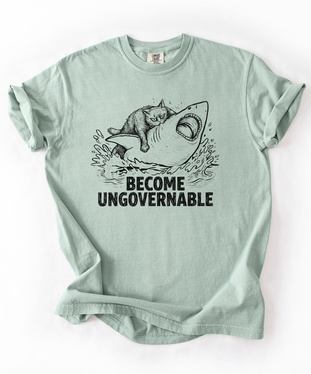 Bay t-shirt with a graphic of a cat on a Shark and the text 'BECOME UNGOVERNABLE'. 