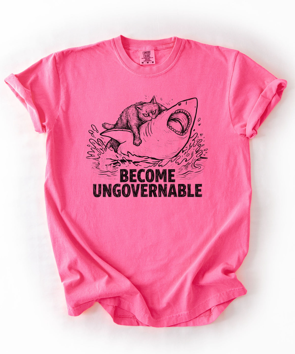 Neon Pink t-shirt with a graphic of a cat on a Shark and the text 'BECOME UNGOVERNABLE'. 