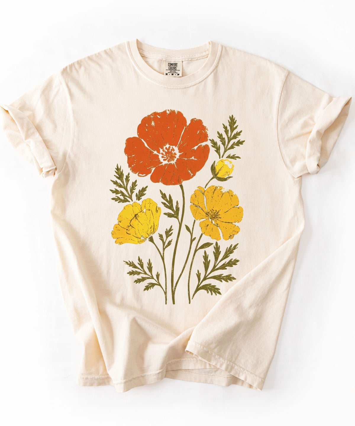 An Ivory-colored short-sleeve t-shirt with a vintage-style graphic print of orange, yellow, and green flowers, laid flat against a white background.