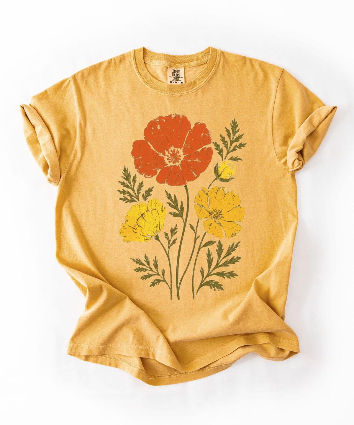 A mustard yellow short-sleeve t-shirt with a graphic print of three poppy flowers in red, yellow, and orange, displayed flat 