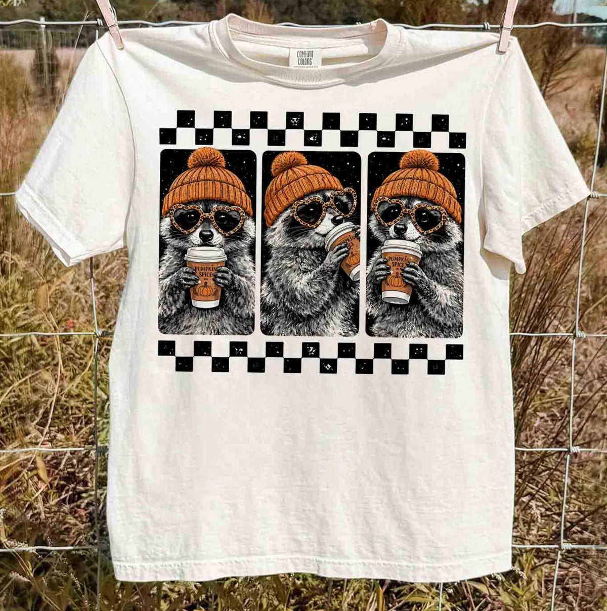 White raccoon pumpkin spice coffee t-shirt — retro beanie raccoon checkerboard graphic fall tee
