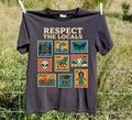 Black Respect the Locals cryptid T-shirt with colorful vintage monster stamps outdoors