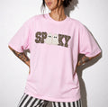 Woman wearing Blossom Comfort Colors t-shirt with leopard print SPOOKY ghost graphic