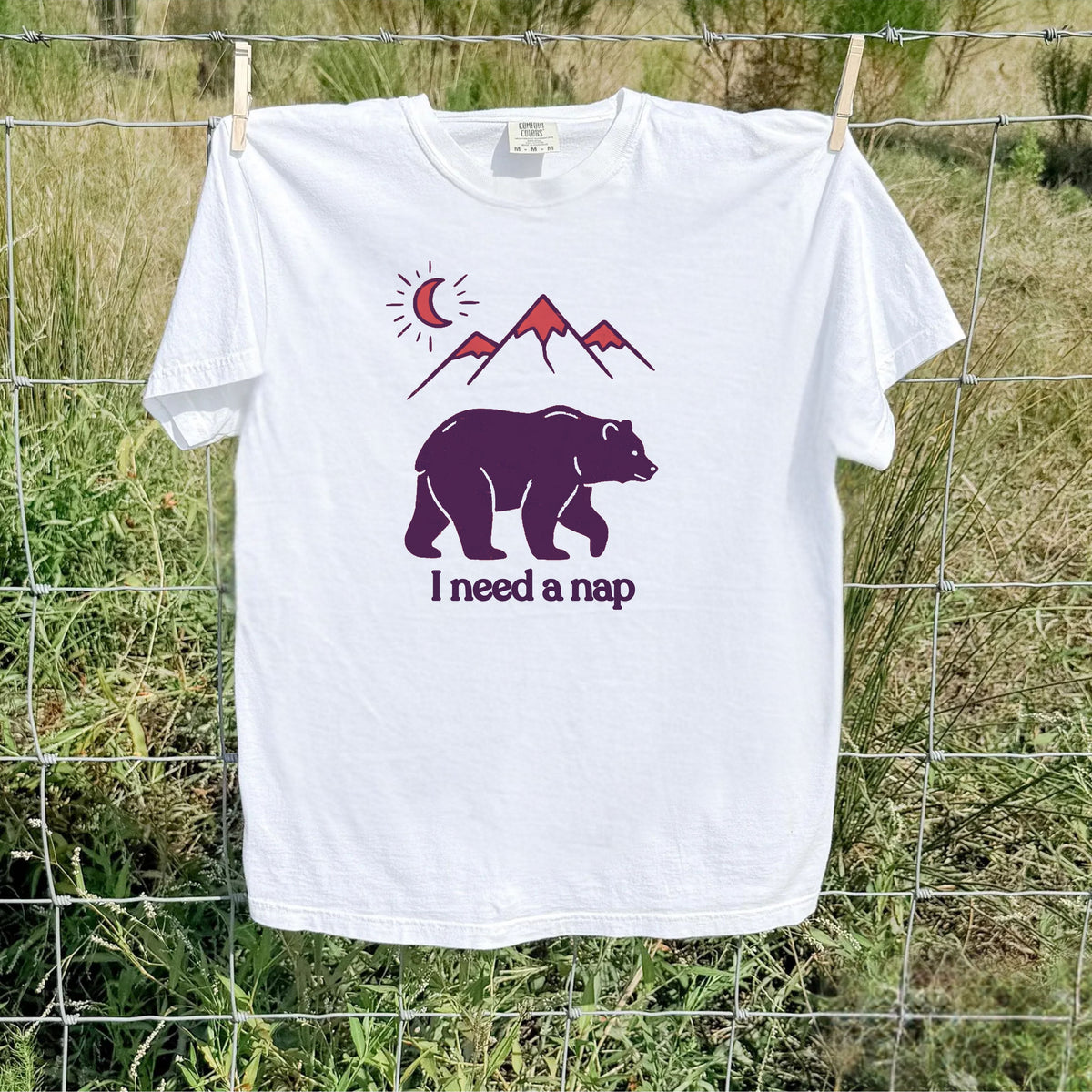White colored Bear and mountain graphic tee, flat lay