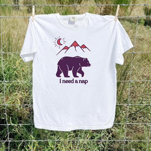 White colored Bear and mountain graphic tee, flat lay