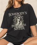 Black Comfort Colors Somebody’s Feral Ass Sister tee featuring Medusa with snake hair and a lollipop held to her lips.