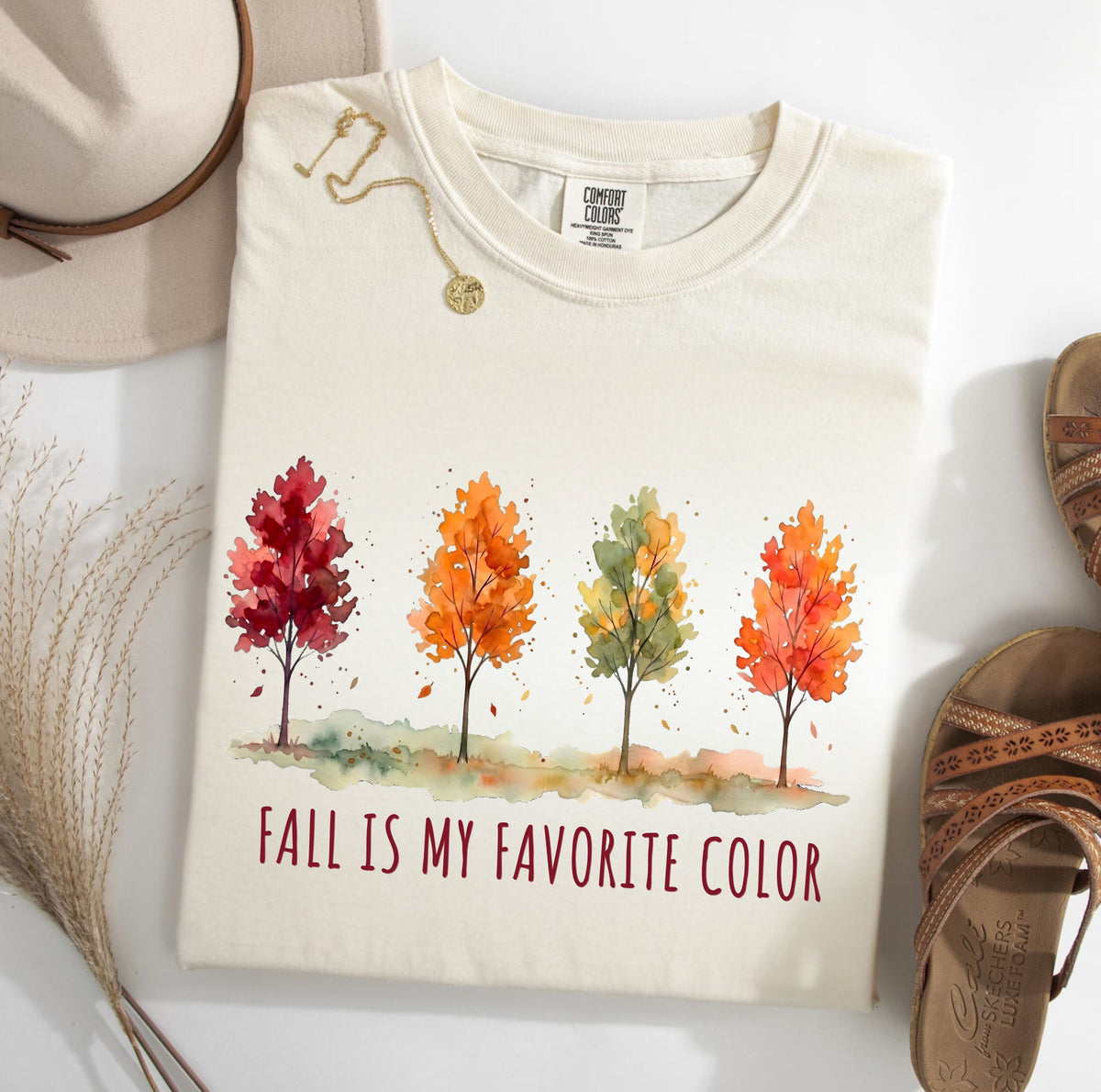 Ivory Fall Is My Favorite Color T-shirt featuring four watercolor-style autumn trees and fall-themed lettering.