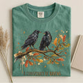 Moss Comfort Colors tee featuring two ravens on an oak branch with autumn leaves and “A Conspiracy of Ravens” text.